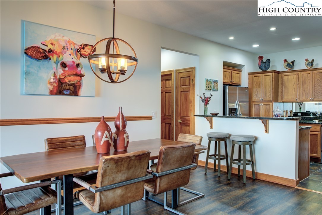 202 Pleasant View, Unit 9D Sugar Mountain, NC 28604 - Photo 22 of 48 a view of a dining room with furniture and wooden floor
