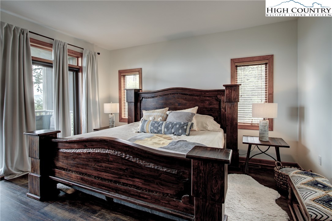 202 Pleasant View, Unit 9D Sugar Mountain, NC 28604 - Photo 27 of 48 a bedroom with a bed and wooden floor