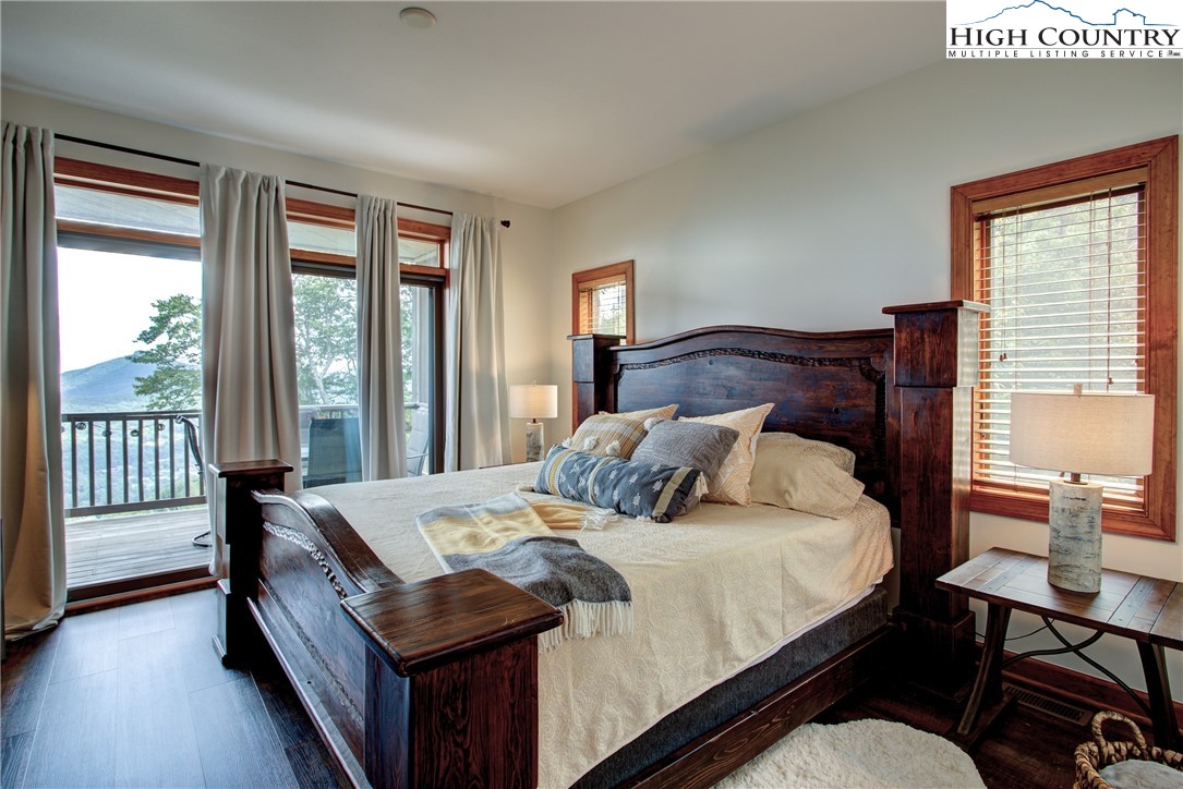 202 Pleasant View, Unit 9D Sugar Mountain, NC 28604 - Photo 28 of 48 a bedroom with a bed and a large window