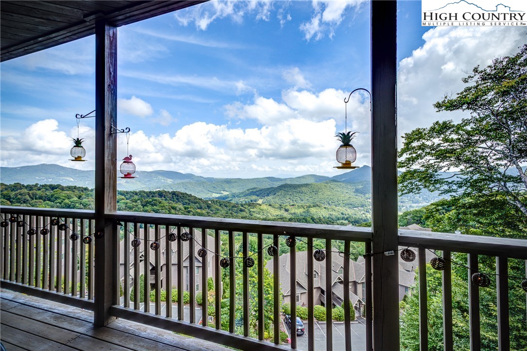 202 Pleasant View, Unit 9D Sugar Mountain, NC 28604 - Photo 29 of 48 a view of a balcony with floor to ceiling window wooden fence