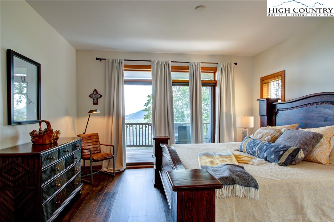 202 Pleasant View, Unit 9D Sugar Mountain, NC 28604 - Photo 30 of 48 a bedroom with furniture and a window