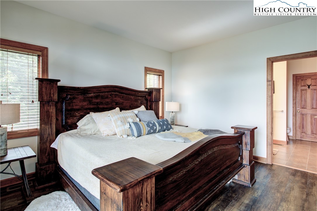 202 Pleasant View, Unit 9D Sugar Mountain, NC 28604 - Photo 32 of 48 a bed sitting in a bedroom next to a window