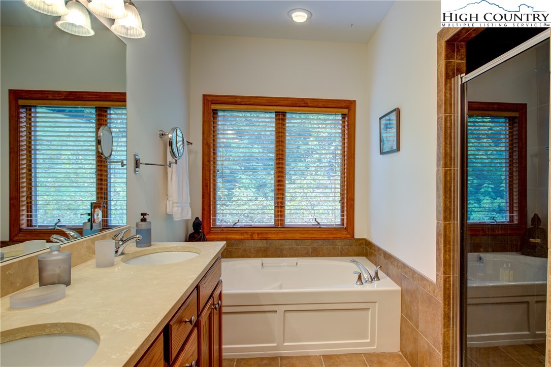 202 Pleasant View, Unit 9D Sugar Mountain, NC 28604 - Photo 34 of 48 a bathroom with a granite countertop sink and a window