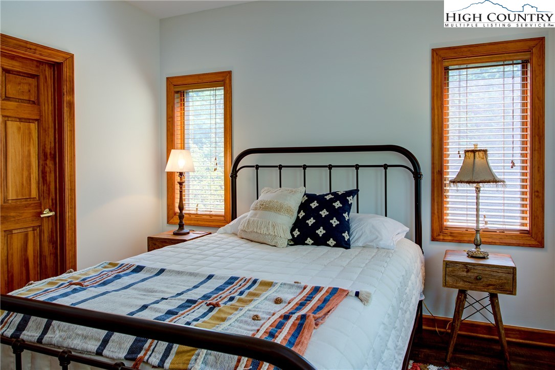 202 Pleasant View, Unit 9D Sugar Mountain, NC 28604 - Photo 36 of 48 a bedroom with a bed and wooden floor