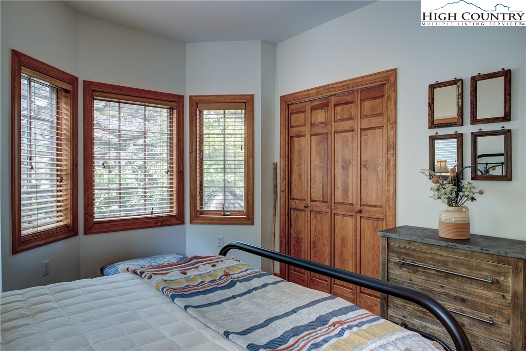 202 Pleasant View, Unit 9D Sugar Mountain, NC 28604 - Photo 37 of 48 a bedroom with a bed and a window