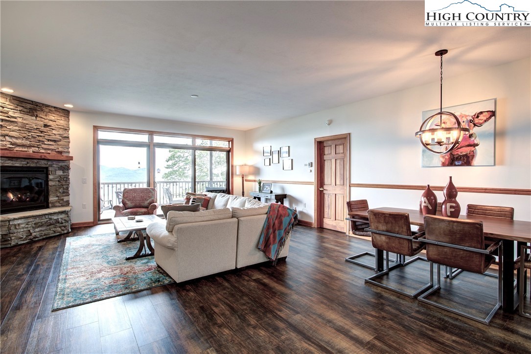 202 Pleasant View, Unit 9D Sugar Mountain, NC 28604 - Photo 9 of 48 a living room with furniture a flat screen tv and wooden floor