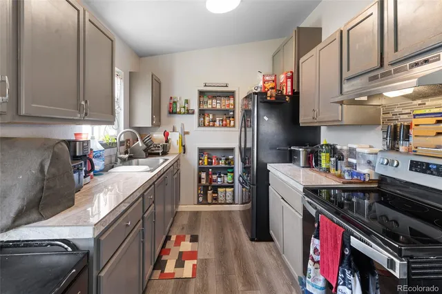 a kitchen with stainless steel appliances granite countertop a stove and a refrigerator
