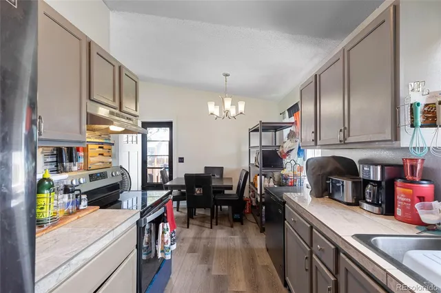 a kitchen with kitchen island granite countertop lots of counter top space and wooden floor