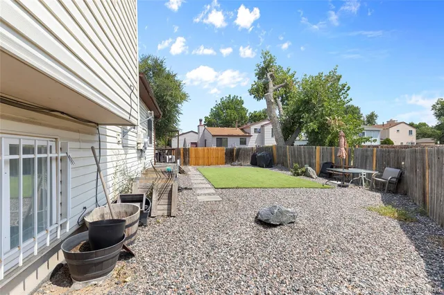 a view of a backyard with sitting area