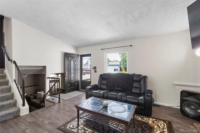 a living room with furniture a window and a fireplace