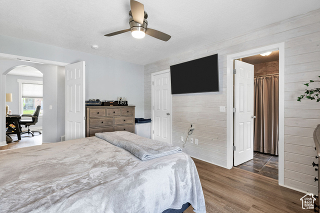 2280 South 450 West Perry, UT 84302 - Photo 17 of 38 Bedroom with dark wood finished floors, arched walkways, a ceiling fan, and a closet