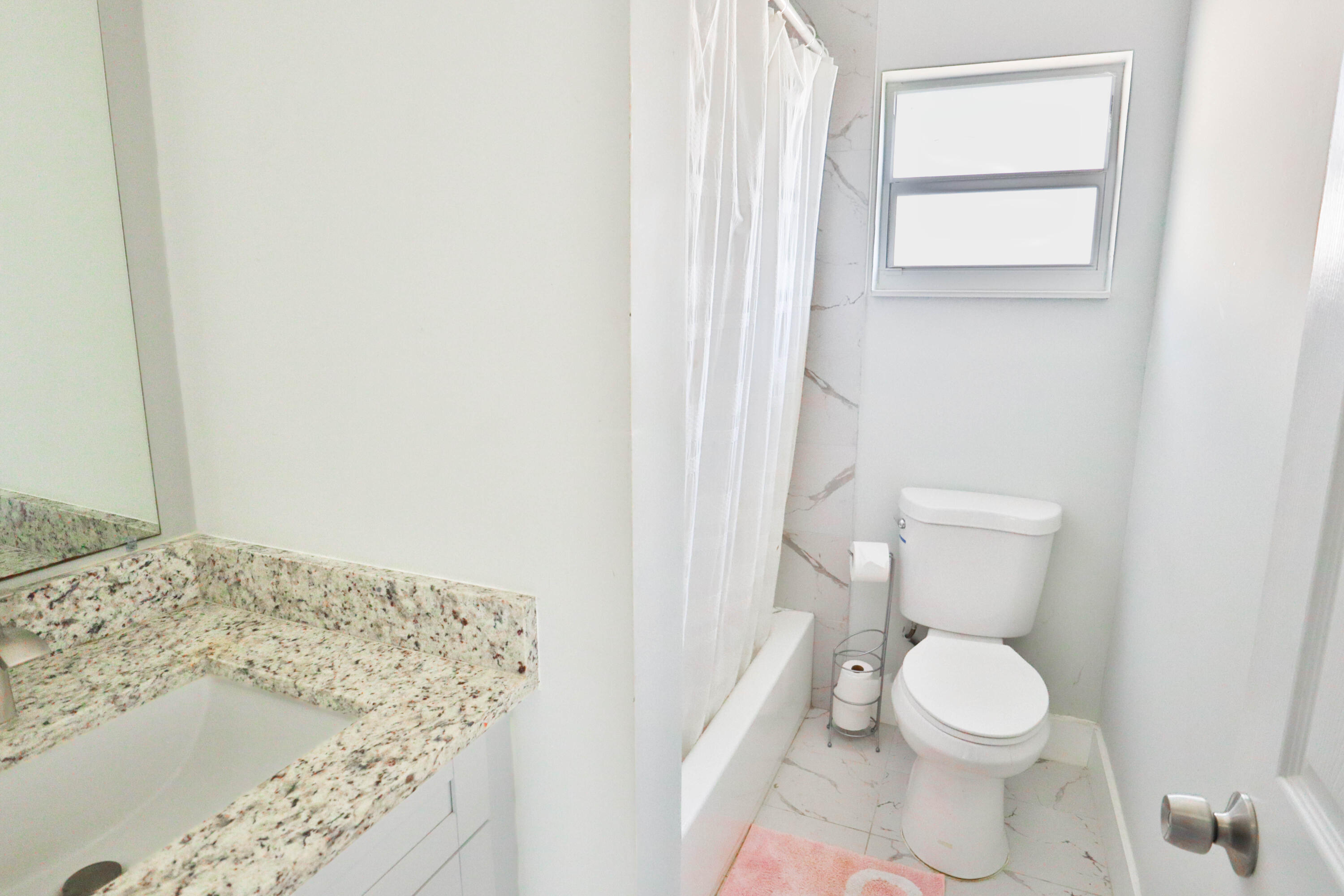 6120 North Dixie Highway Boca Raton, FL 33487 - Photo 13 of 25 a bathroom with a toilet and a window