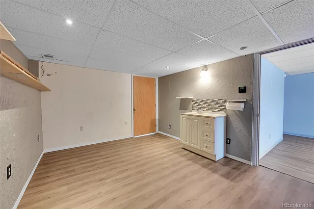 a large white kitchen with granite countertop a sink