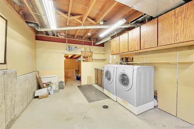 a yellow and red umbrella sitting in front of a house