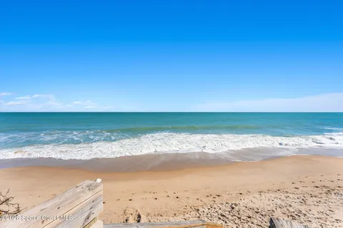 a kitchen with granite countertop white cabinets and window