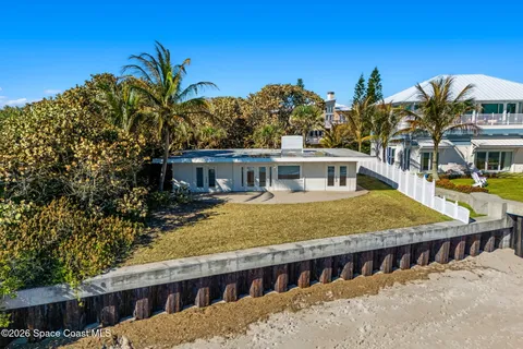 a kitchen with kitchen island granite countertop a sink and a refrigerator