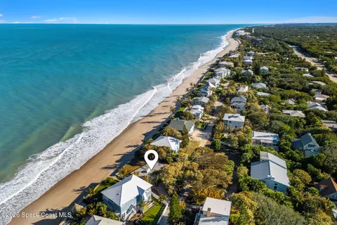 a view of an empty room with window and a fan