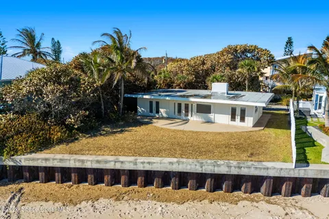 a view of a house with a wooden fence