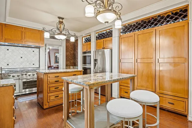 a kitchen with a table chairs stove and wooden floor