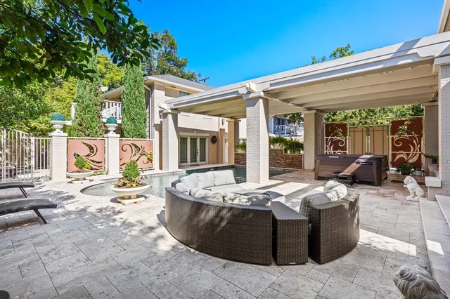 a view of a house with swimming pool and furniture