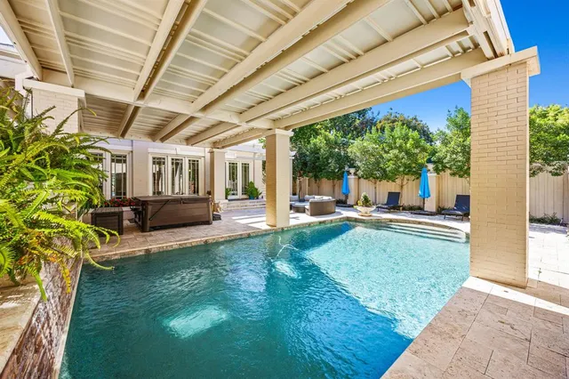 a house with swimming pool in front of it