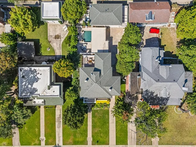 an aerial view of residential houses with city view