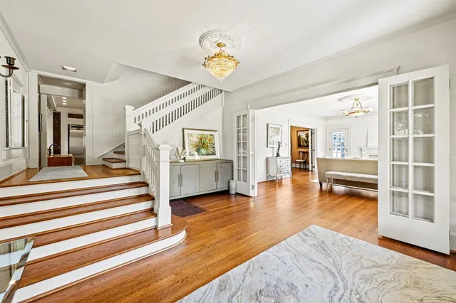 a view of a bedroom with wooden floor and a ceiling fan
