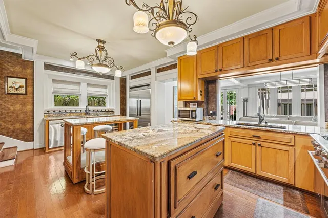 a kitchen with a sink and wooden cabinets
