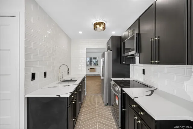 a kitchen with a sink refrigerator and microwave