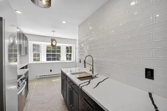 a kitchen with a sink and a stove top oven