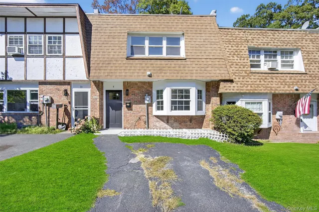 a view of a house with a yard and a garden