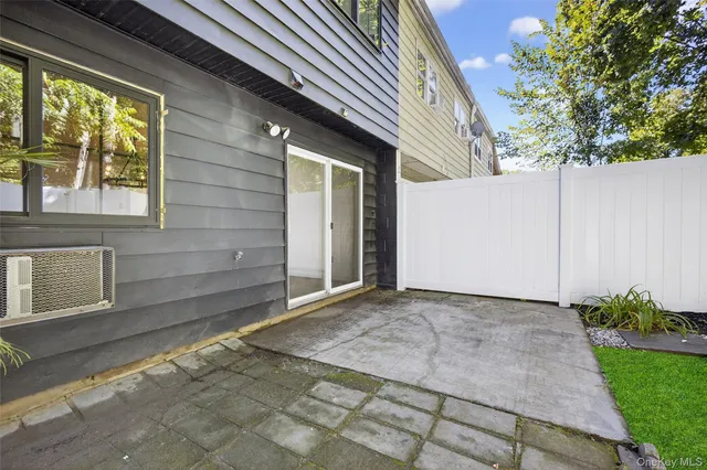 a backyard of a house with plants and trees