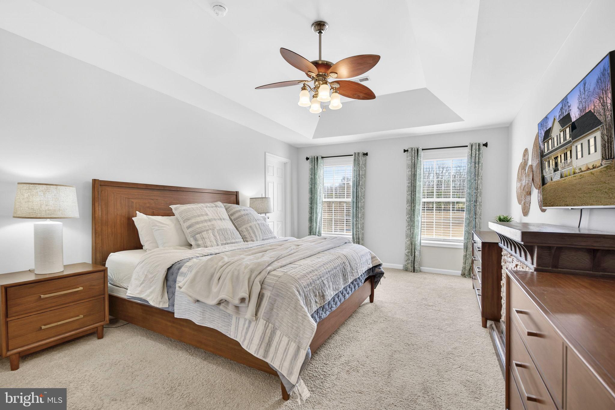 23 Richmond Road Castleton, VA 22716 - Photo 16 of 46 a spacious bedroom with a bed and a chandelier