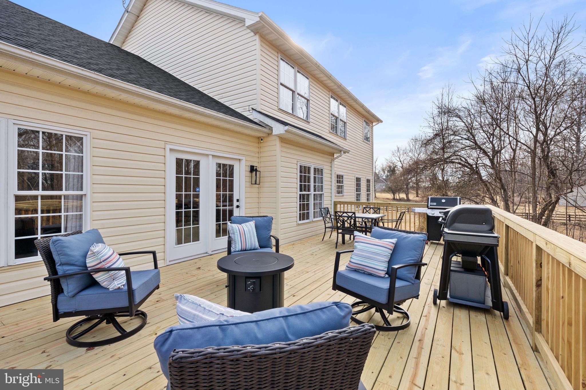 23 Richmond Road Castleton, VA 22716 - Photo 30 of 46 a view of a patio with couches chairs and a barbeque