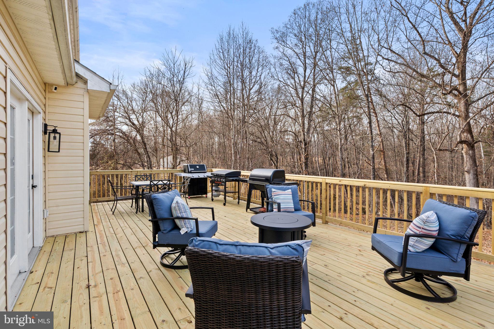 23 Richmond Road Castleton, VA 22716 - Photo 31 of 46 a view of a roof deck with table and chairs couches and wooden floor
