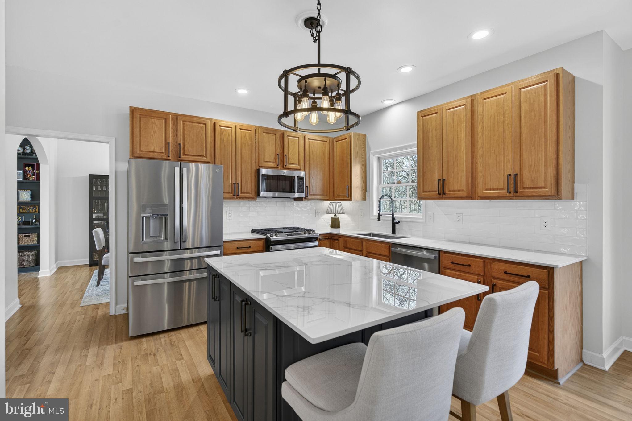 23 Richmond Road Castleton, VA 22716 - Photo 6 of 46 a kitchen with stainless steel appliances granite countertop a sink refrigerator and cabinets
