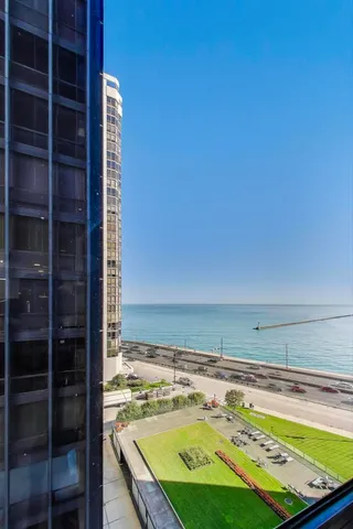 a kitchen with stainless steel appliances granite countertop a sink a stove a refrigerator and island with wooden floor