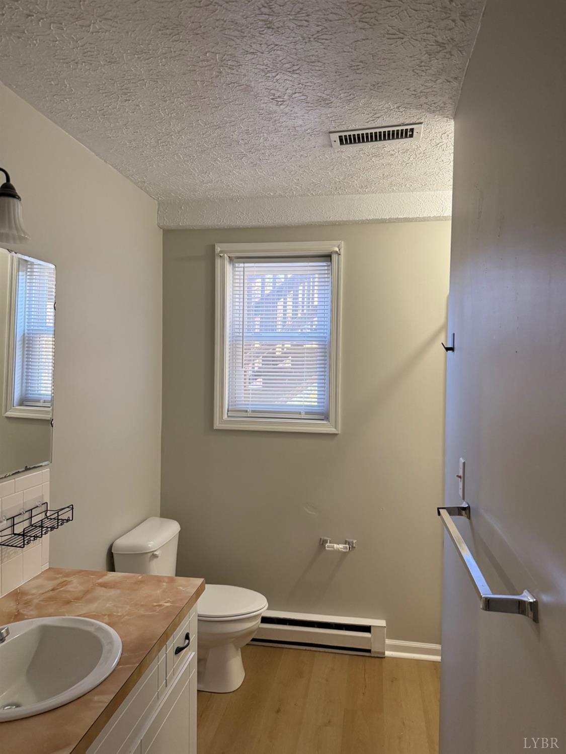 112 Wooldridge Circle Lynchburg, VA 24502 - Photo 18 of 29 a bathroom with a granite countertop sink mirror vanity and toilet