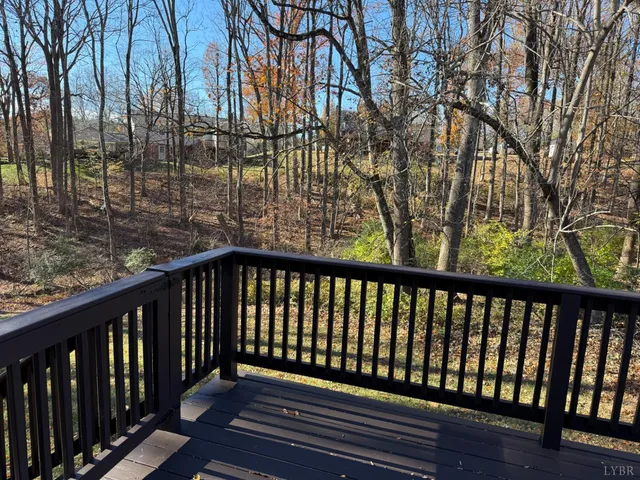 a balcony with wooden floor and fence