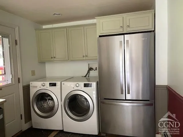 a view of kitchen with stainless steel appliances refrigerator and cabinets