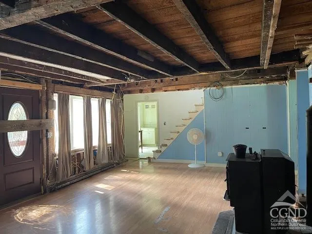 a view of empty room with wooden floor