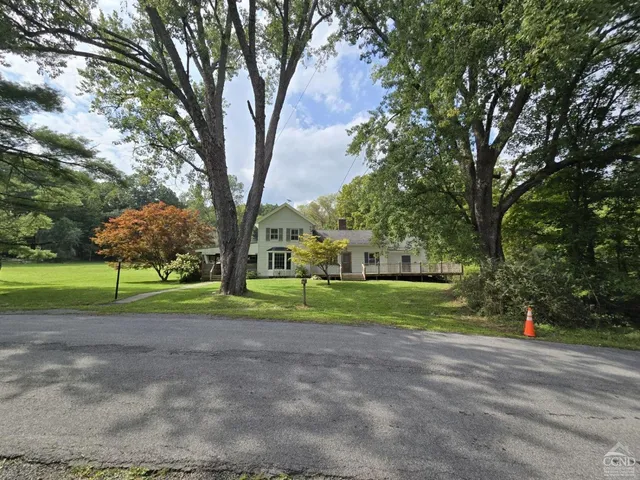 a view of road with large trees