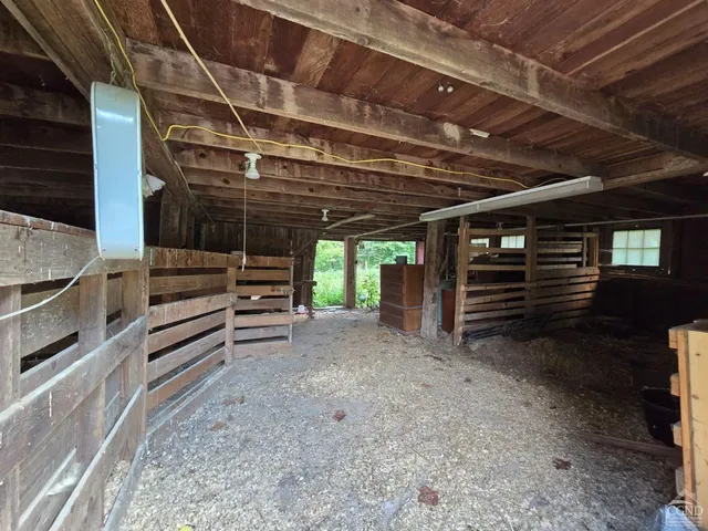 a view of empty room with wooden ceiling