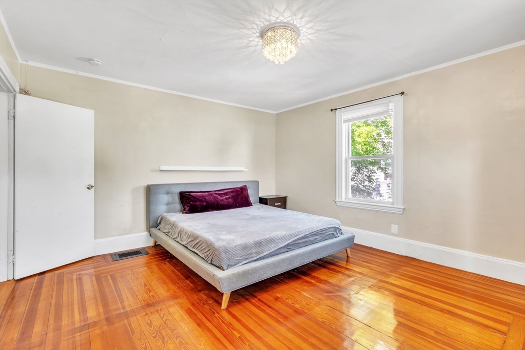 49 Laurel Street Watertown, MA 02472 - Photo 20 of 42 a bedroom with a bed and a window