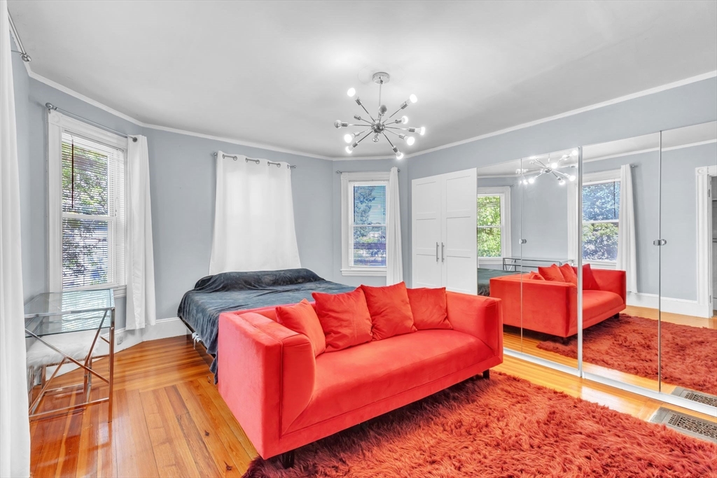 49 Laurel Street Watertown, MA 02472 - Photo 22 of 42 a living room with furniture and a chandelier