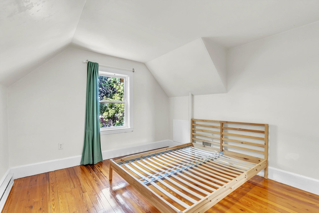 49 Laurel Street Watertown, MA 02472 - Photo 28 of 42 a bedroom with a bed and a window