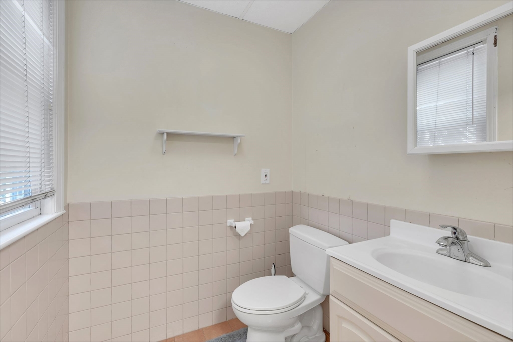 49 Laurel Street Watertown, MA 02472 - Photo 30 of 42 a bathroom with a sink a toilet and a mirror