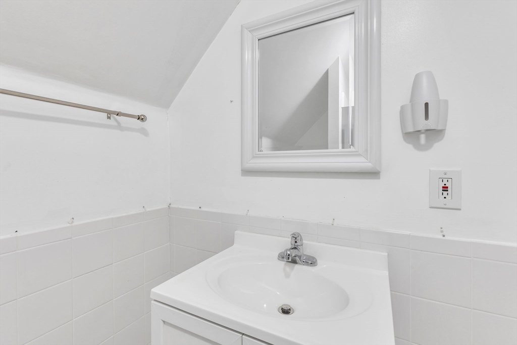 49 Laurel Street Watertown, MA 02472 - Photo 32 of 42 a bathroom with a sink a vanity and mirror