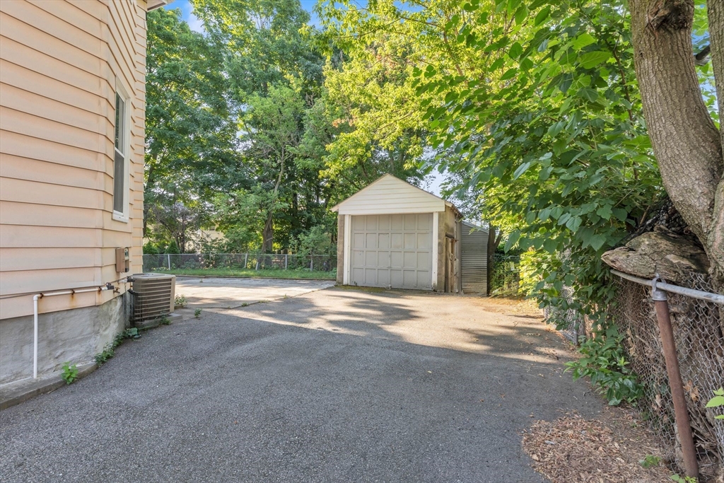 49 Laurel Street Watertown, MA 02472 - Photo 36 of 42 a house with trees in front of it