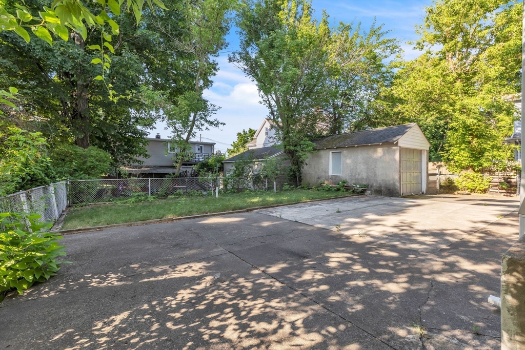 49 Laurel Street Watertown, MA 02472 - Photo 6 of 42 a view of a yard with potted plants and large trees